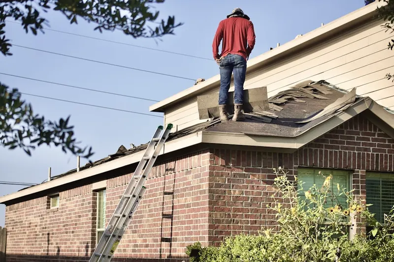 Professional roofer working on a residential roof in Solitude